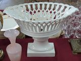 a white bowl sitting on a table next to other glassware