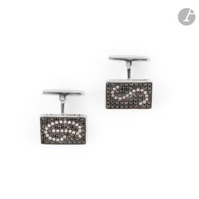 a pair of black and white diamond cufflinks on a white background