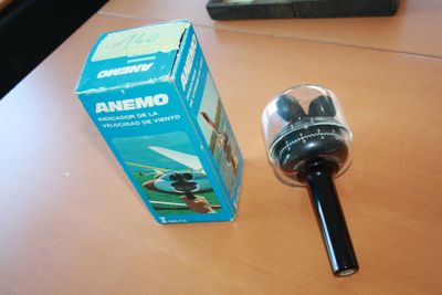 a bottle of wine sitting on a table next to a box of anemo