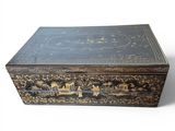 a black and gold box with a train design on it