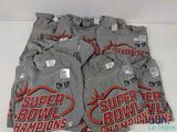 six super bowl champs t - shirts are stacked on top of each other