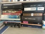 many books stacked on top of each other on a shelf