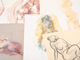 many drawings of a woman on a table