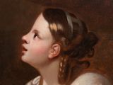 portrait of a young girl holding a glass of wine in her hand