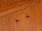 a close up of a wooden cabinet with two knobs