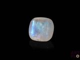 a white moons stone on a black surface