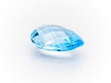 a close up of a blue diamond on a white background