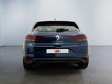 the rear end of a blue car in a white room