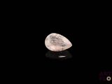 a close up of a white diamond on a black surface