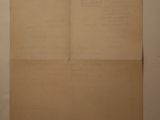 a piece of paper hanging on a wall next to a window