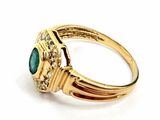 an image of a close up of a gold ring with a green stone