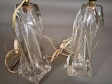 pair of clear glass lamps with gold trims on a table