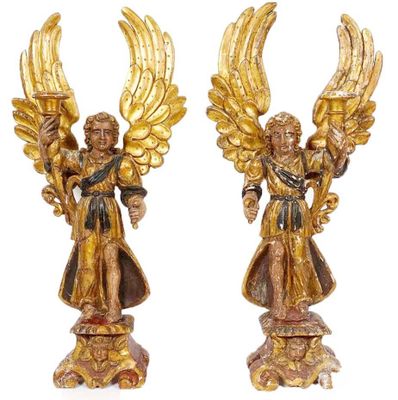 pair of gold angel figurines with wings on pedestal