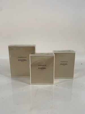 three boxes of chanel perfume sitting on top of a table