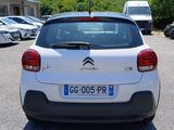 a small white car parked in a parking lot