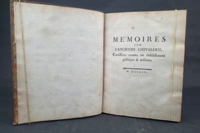 an old book opened to show the title of a poem