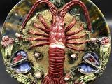 a decorative plate with a lobster on it on a table