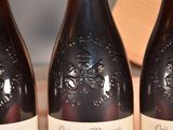 three bottles of wine that are sitting on a table