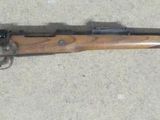 a close up of a rifle laying on the ground on a floor