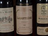 several bottles of wine are lined up on a table