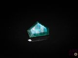 a close up of a green emerald stone on a black surface
