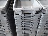 many plastic bins stacked on a pallet in a warehouse