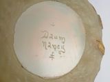a white bowl with writing on it sitting on a table