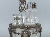 a silver plate with a glass decanter on top of it