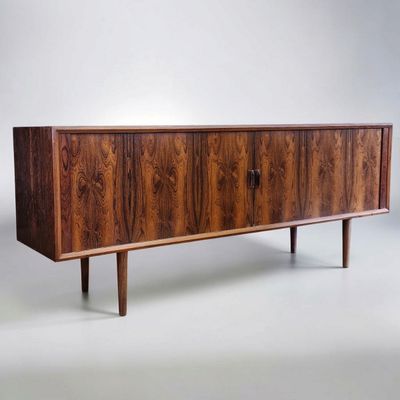 the sideboard is made of wood and has three drawers