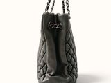 the large black bag has a chain handle on it