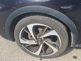 a close up of a car ' s wheel on the street