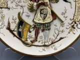 a decorative plate with a picture of a man holding a sword