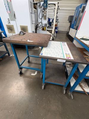 a workbench in the middle of a room with a lot of work on it