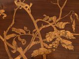 a bird sitting on a branch of a tree on a table
