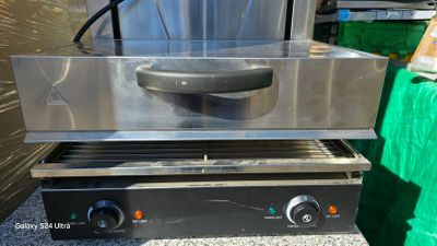 an image of a commercial grill with a large pan on top of it