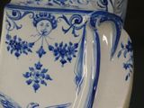 a blue and white vase with a bird on it