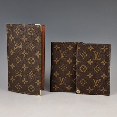 two louis vuittois notebooks, one brown and one brown