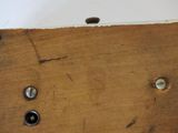 a close up of a piece of wood with screws on it
