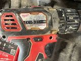 a cordless drill that is sitting on top of a pile of other tools