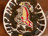 a plate with a design on it sitting on a table