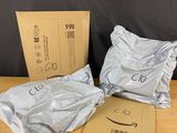 three bags of amazon boxes sitting on top of a wooden table