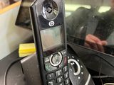 a phone that is sitting on a desk next to a laptop