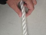 a person holding a white rope on a table