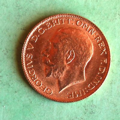 a penny on a table with a green background