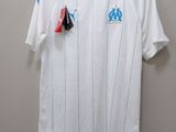 the shirt is white with blue and red stripes on it