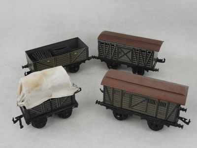 three toy train cars are shown in a row on a white surface