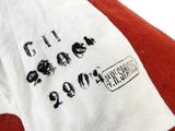 a white and red shirt with black writing on it