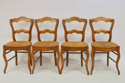 four wooden chairs are lined up against a white background