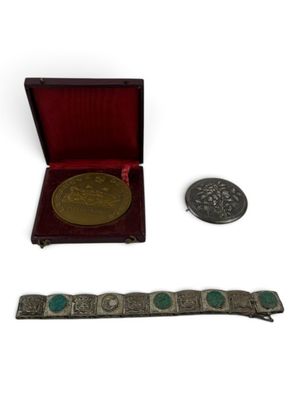 an image of a silver and turquoise bracelet and a silver coin