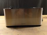 an image of a toaster sitting on top of a wooden table